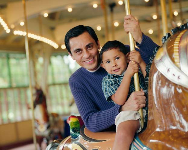 man and boy on carousel 