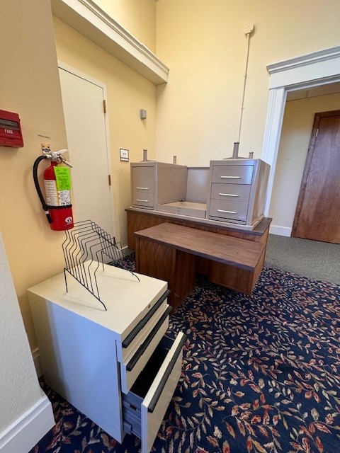 metal desk and a second L-shaped desk