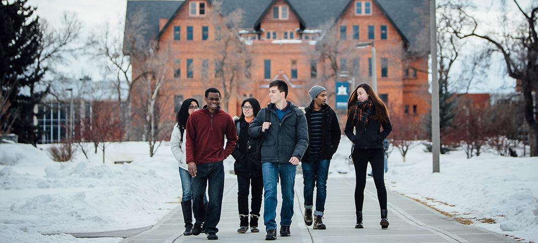 Several students walking on campus in winter.