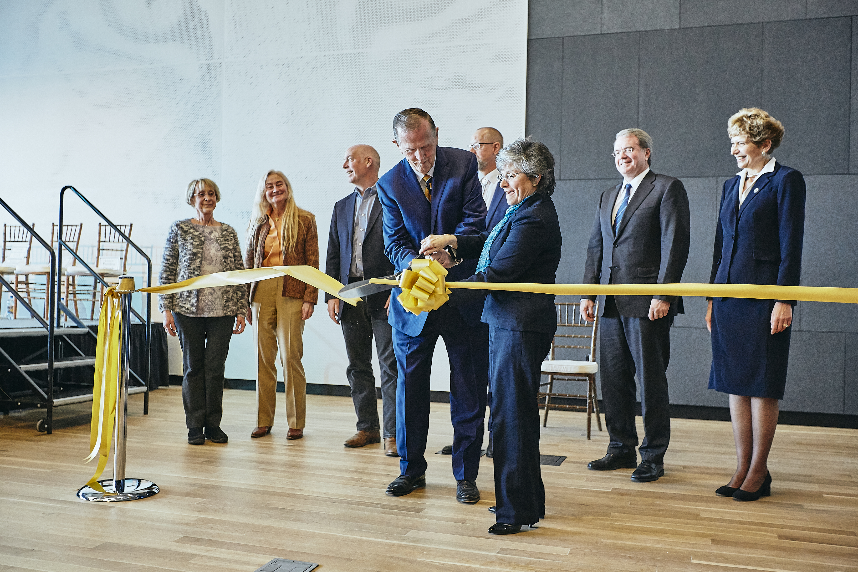 Staff and faculty participate in a ribbon cutting ceremony.