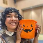 Student holding pumpkin at the AIC Halloween Party 