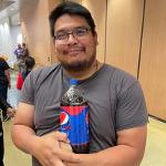 Staff member Nick Ross at the AIC Halloween Party 2022 holding a Pepsi