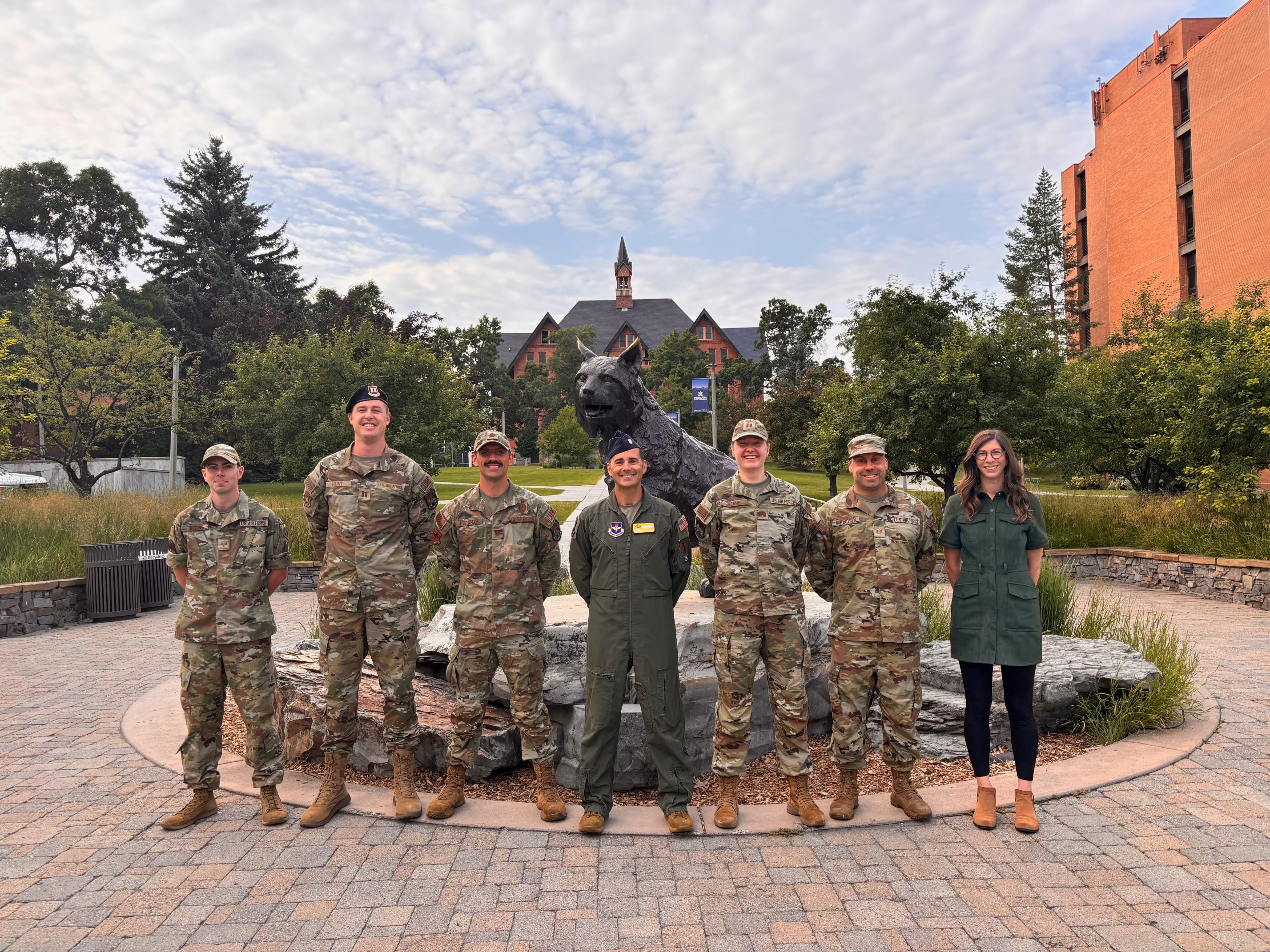 AFROTC Det 450 Cadre members in uniform standing in front of the Bobcat Statue at Montana State University