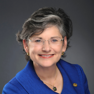 Portrait of Waded Cruzado in a studio, wearing a blue outfit. 