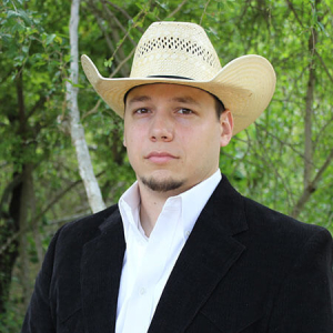 A young man in a cowboy hat and jacket