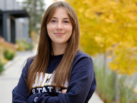 Cadee Hess standing in front of trees with yellow leaves wearing a Montana State sweatshirt. |  MSU photo by Kelly Gorham