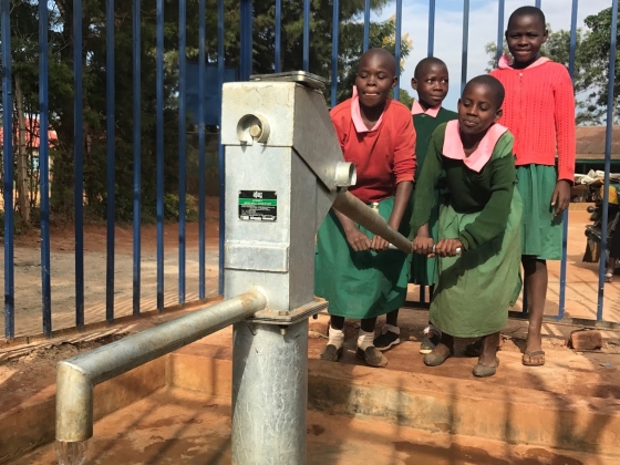 Kenyan children pumping a new well installed with help from MSU Engineers Without Borders | 