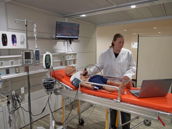 Bernadette McCrory in a clinical medical setting conducting an ultrasound on a life-like mannequin on a medical bed. | MSU photo by Kelly Gorham