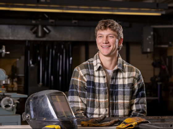 Kyle Henry in a shop with welding equipment | MSU photo by Marcus "Doc" Cravens