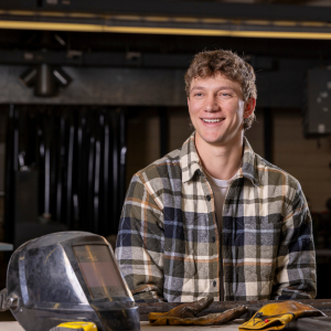 Kyle Henry in a shop with welding equipment