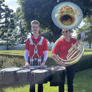Two MSU marching band students, Jackson Queneau and Jackie Olivares, pose for a phot with their instruments, tenor drums and a sousaphone, during the 80th anniversary of D-Day in Normandy, France.