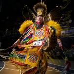 A dancer in traditional Native American regalia dancing