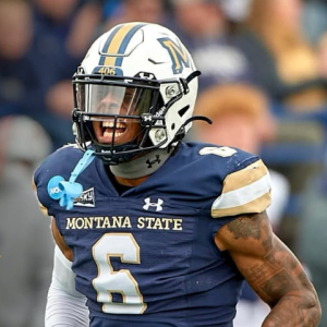 "Montana State University football player wearing a blue and gold uniform celebrates on the field during a game, with the text overlay: 'GO 'CATS! MSU will host Idaho for FCS playoffs. Game at 7 p.m. Friday.'"