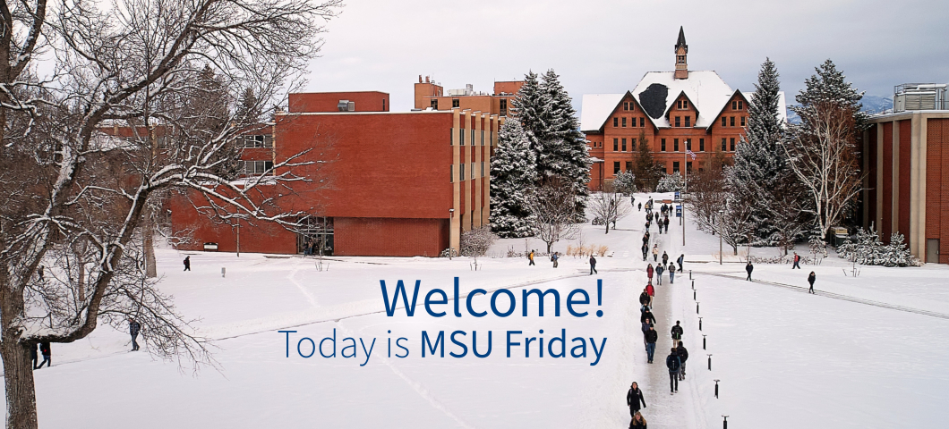 A snowy Montana State University campus scene shows students walking along a cleared pathway toward a historic red-brick building with a snow-covered roof. Surrounding trees and modern campus buildings are also blanketed in snow. Blue and white text over  | MSU