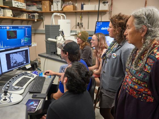 A group of people in front of a computer monitor array. | MSU photo by Colter Peterson