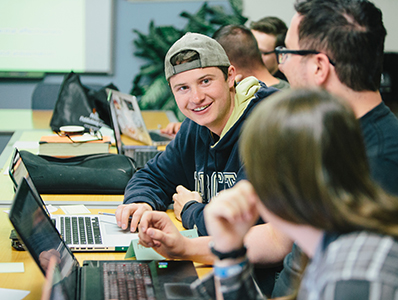 Student smiling at computer