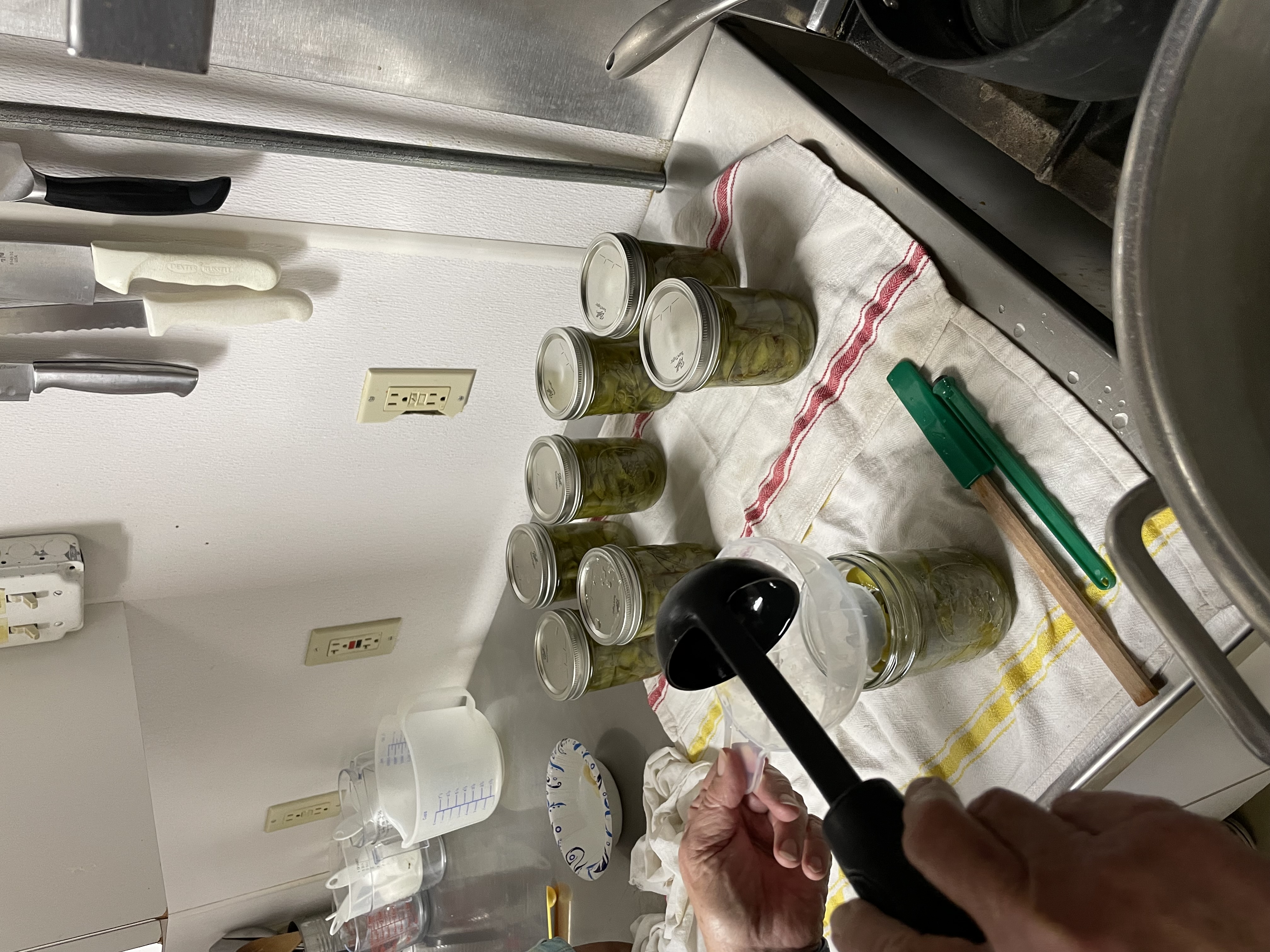 Filling jars with peppers and getting them ready to hot water bath.