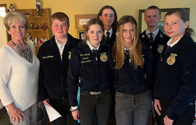 Avice stands with a group of young FFA members in their blue courduroy jackets.