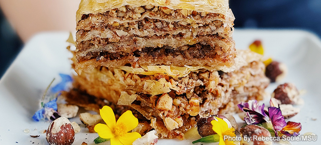 hazelnut baklava displayed on a plate with flowers