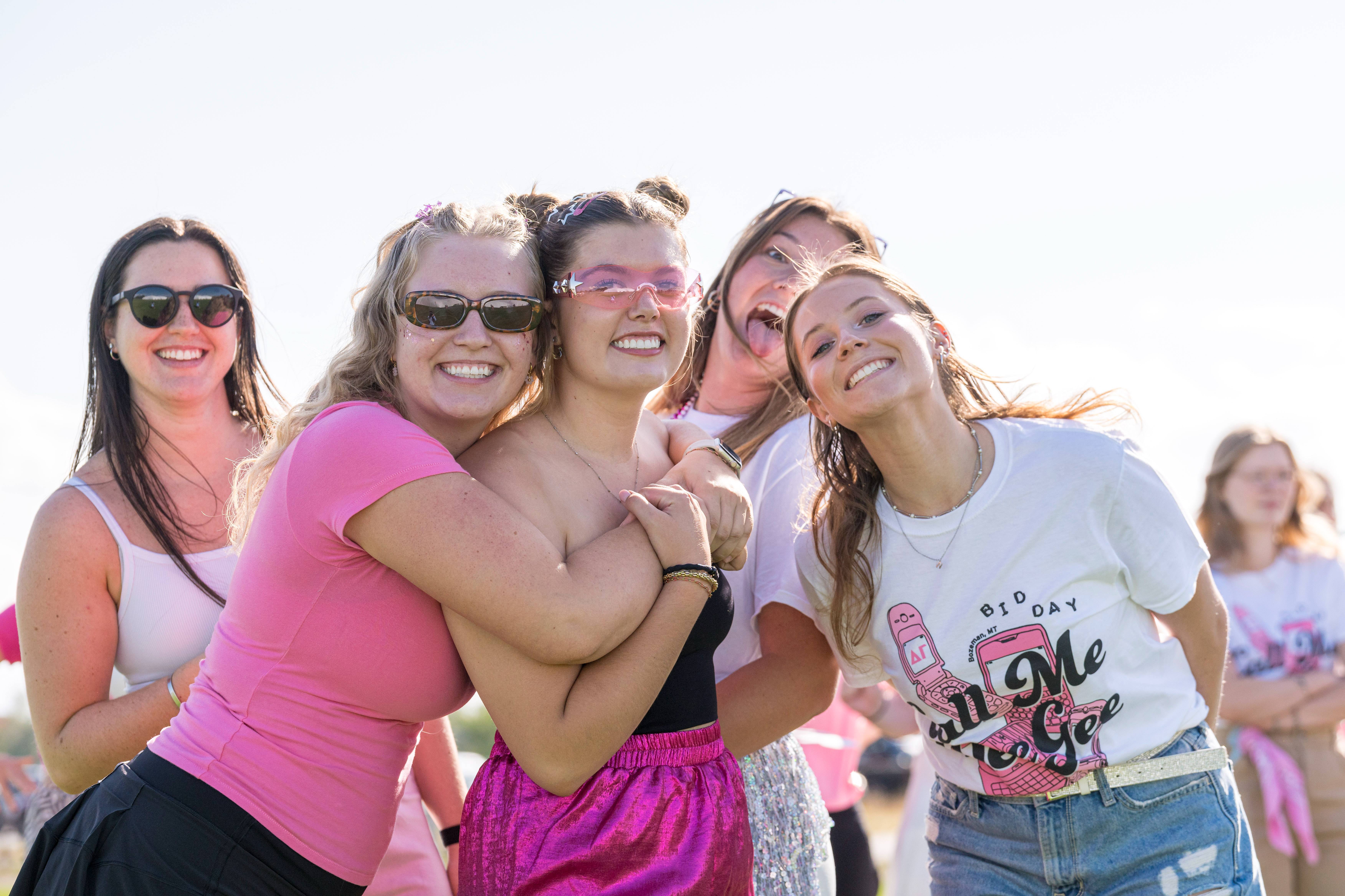 Happy students embracing their new sorority sisters