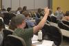 A MSU Hilleman Scholar raises his hand to ask a question during a Lessons in Leadership speaker session