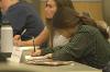 McKenna Arvidson takes notes during a Lessons in Leadership speaker.