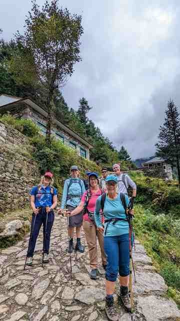 The group poses along an outdoor trail. 