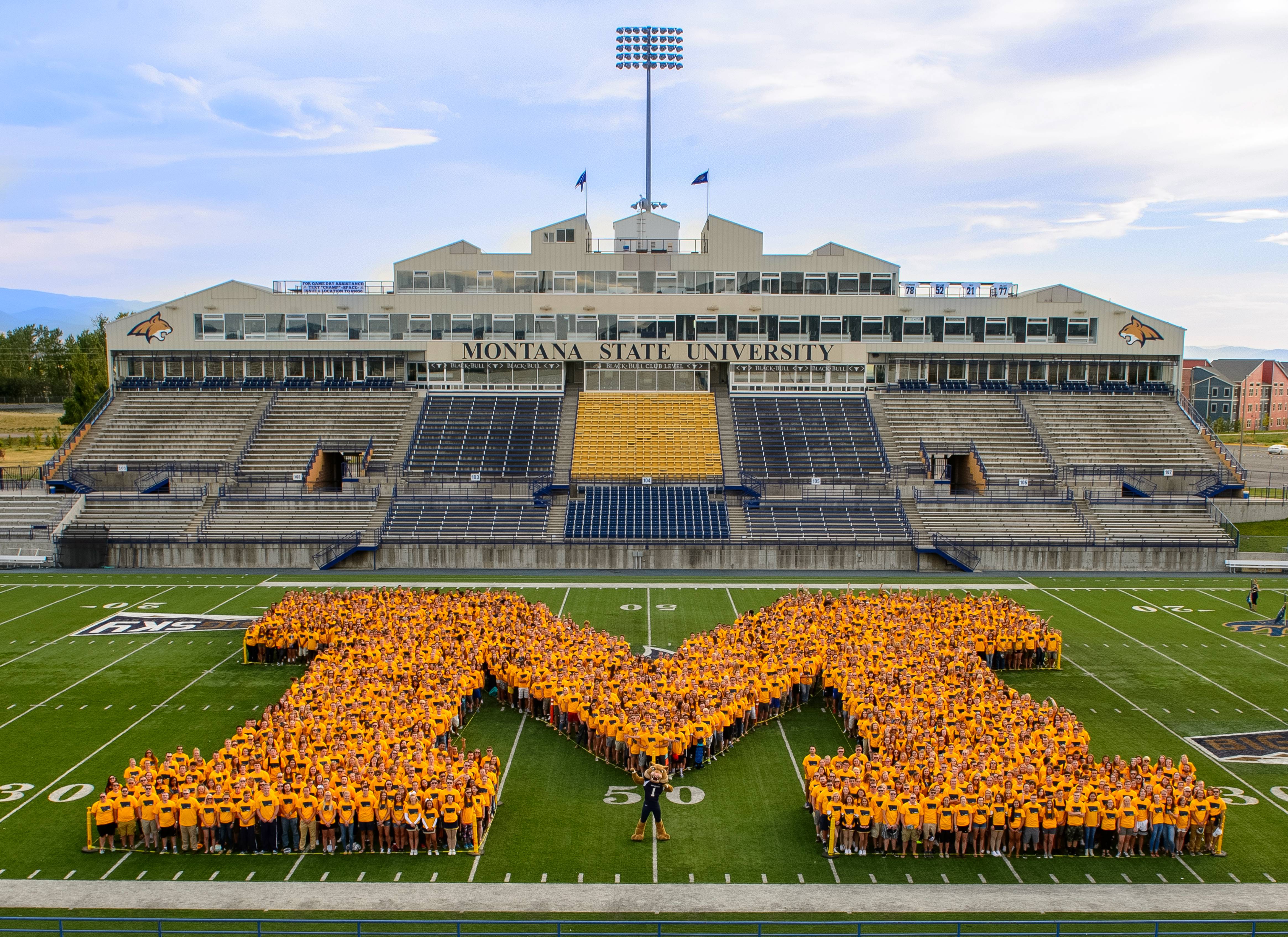 Freshman Students in an "M" formation on the football field