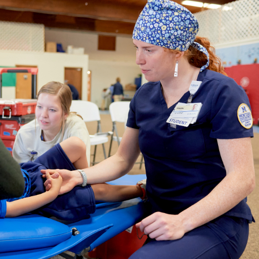 student helping in local community health clinic 