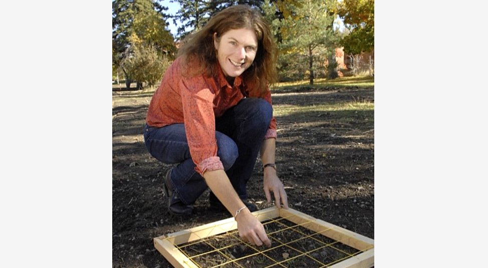 Dr. Rew kneeling over a quadrat 