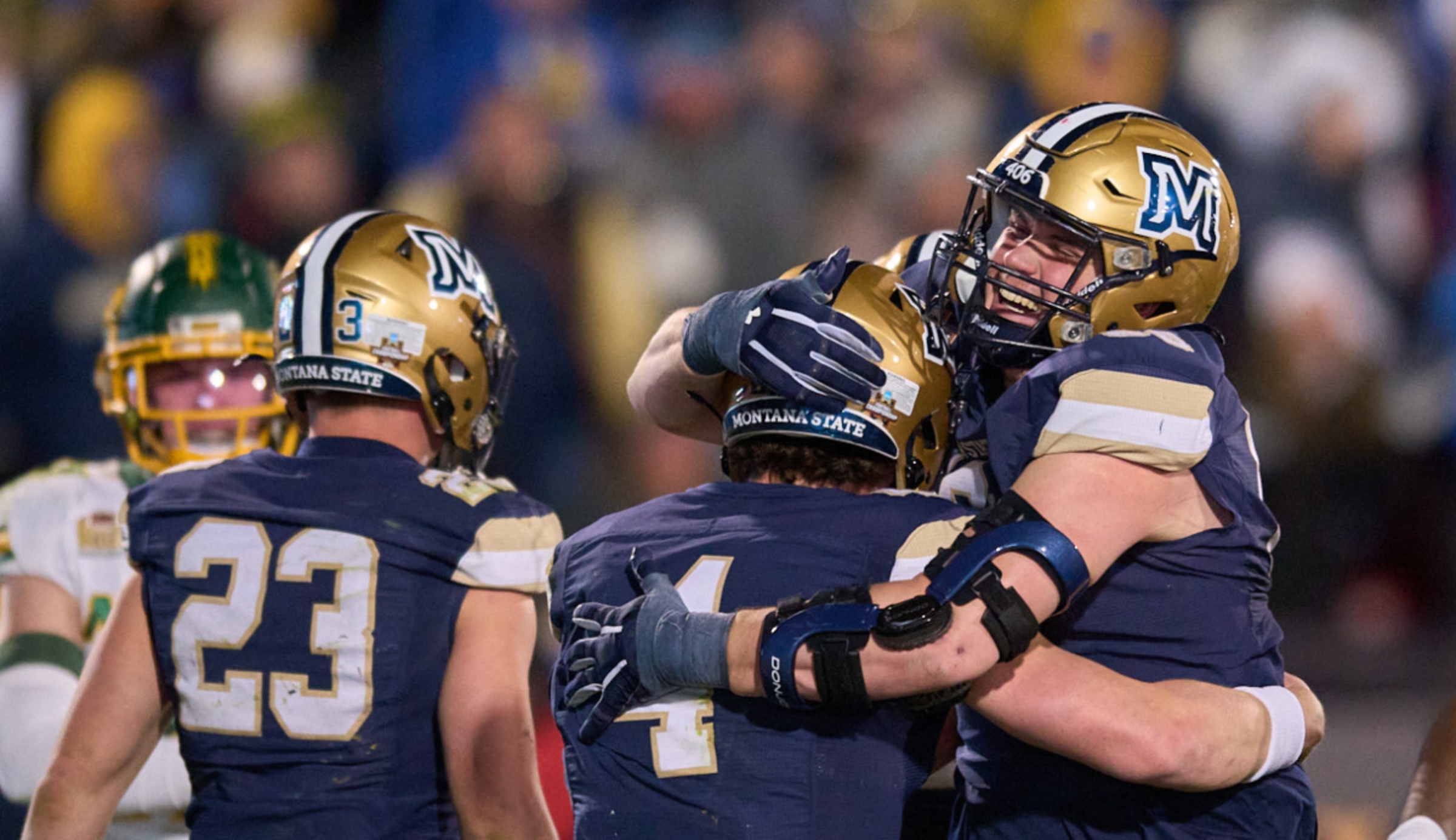 Montana State University football players in blue and gold uniforms celebrate on the field with raised arms and helmets, surrounded by cheering fans in the stands. Text overlay reads, 'Thanks for a great season, ’Cats!'