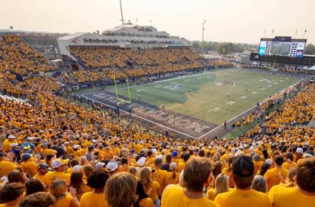 Fans dressed mainly in gold shirts attend a football game at Montana State University in Bozeman. 