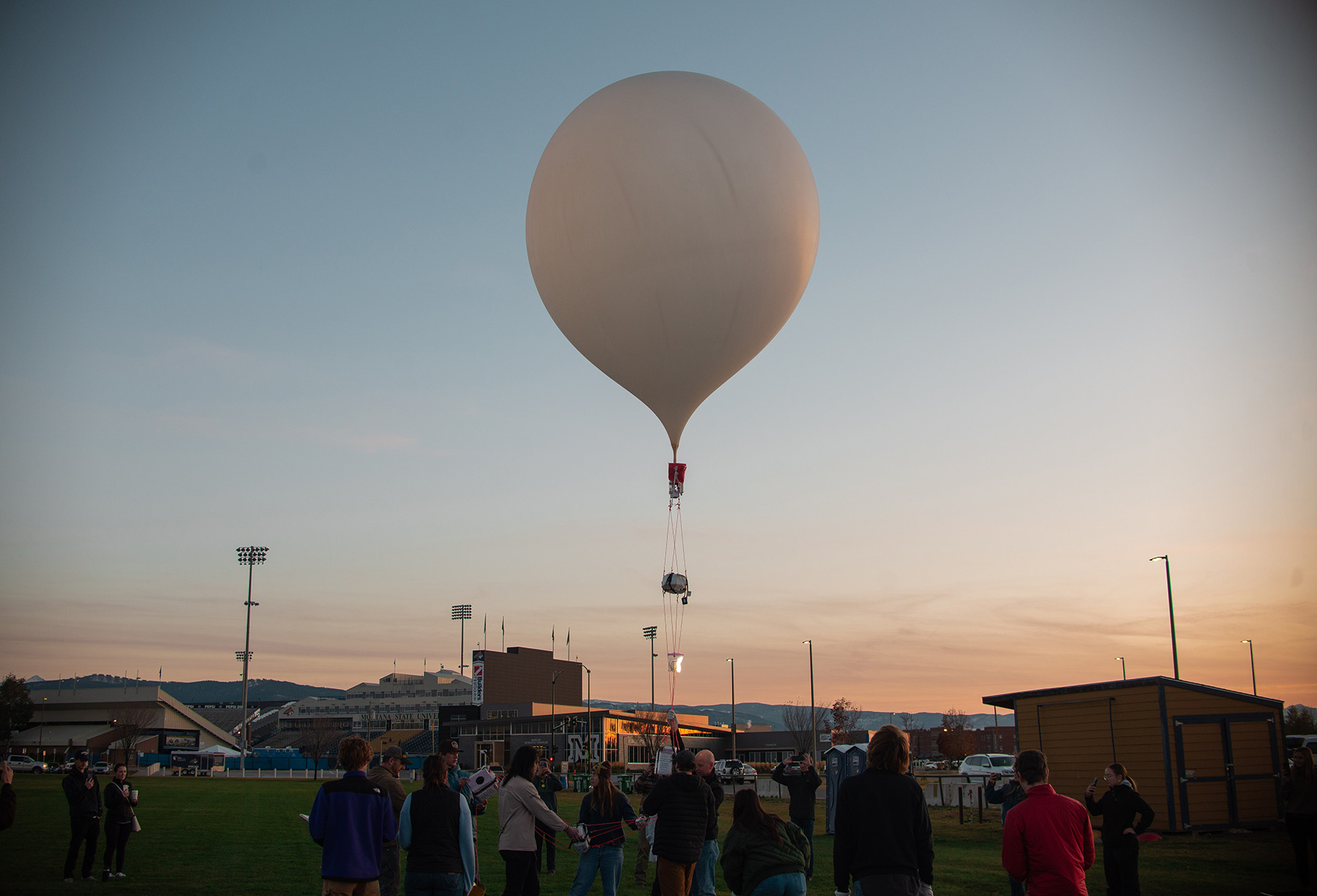 balloon rising at sunset