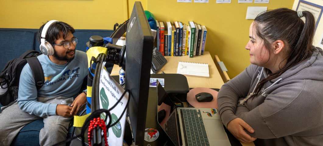 A TRIO Staff member working with an MSU student at a computer