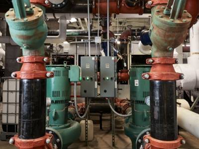 Pipes and heat pumps in the basement of Leon Johnson Hall